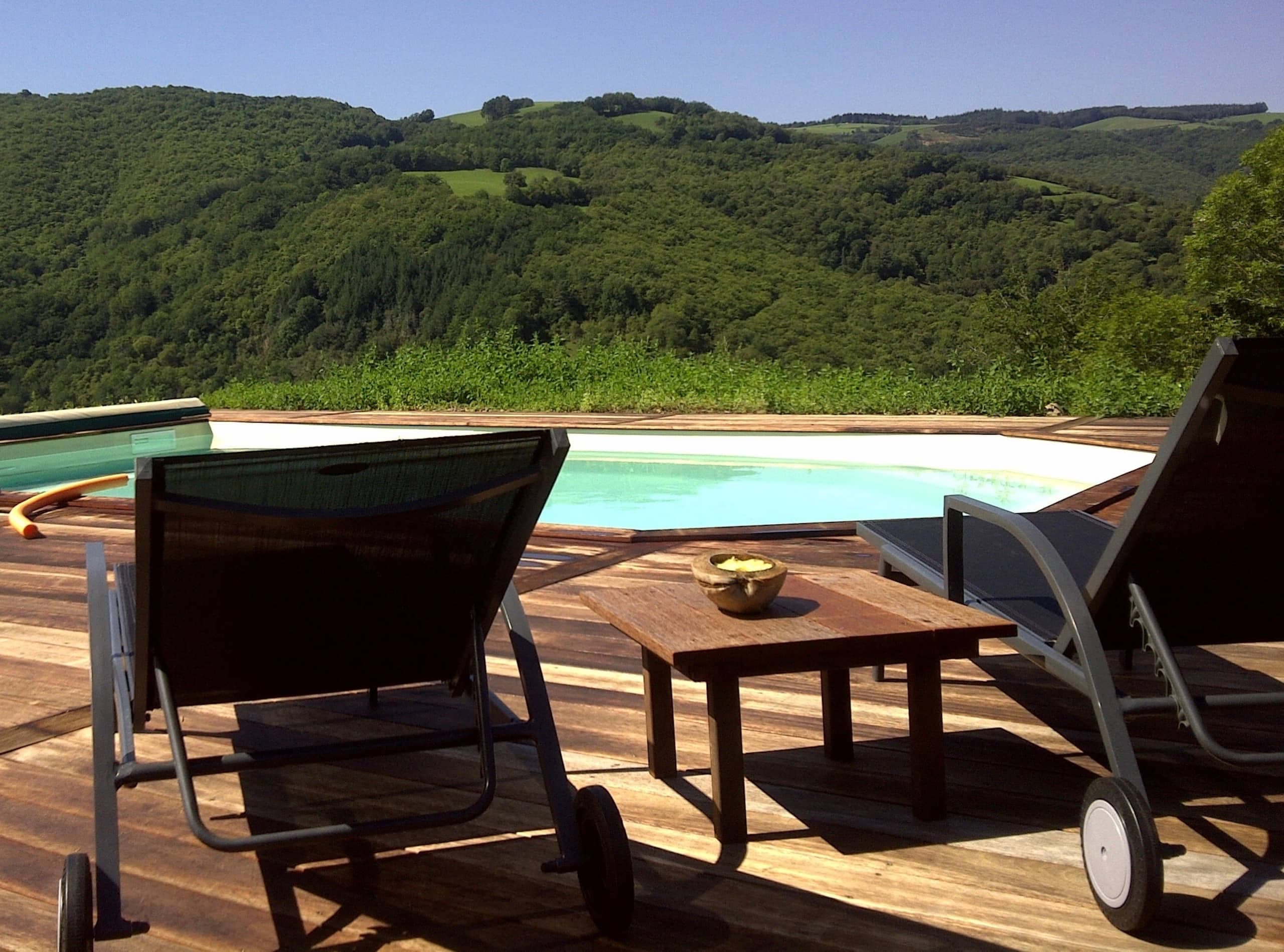 Transats au bord de la piscine chauffée face au panorama